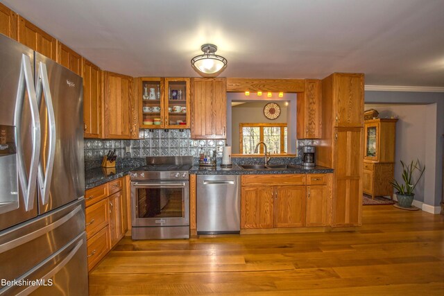 613 Skyline Trl, Chester, MA 01011 - kitchen with a sink, tasteful backsplash, brown cabinets, glass insert cabinets, and appliances with stainless steel finishes