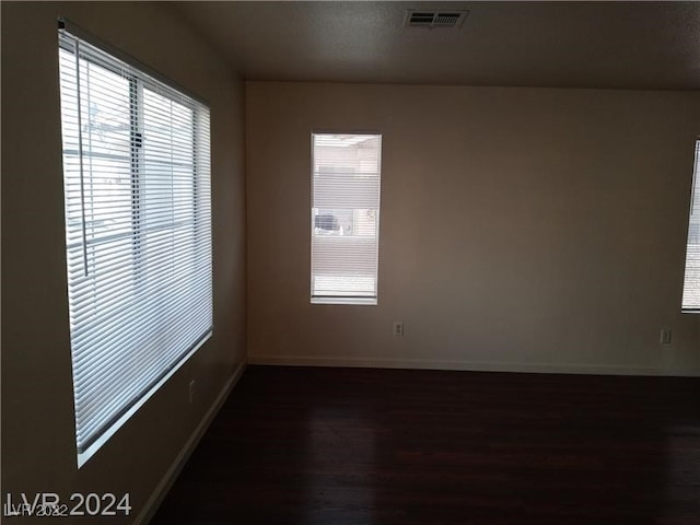 spare room with dark hardwood / wood-style flooring