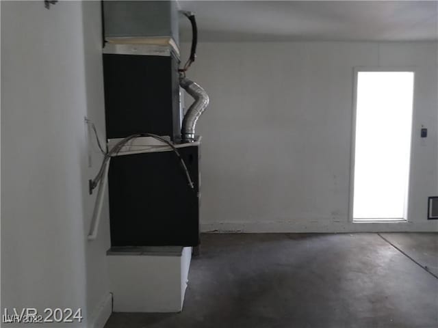 unfurnished living room featuring concrete flooring