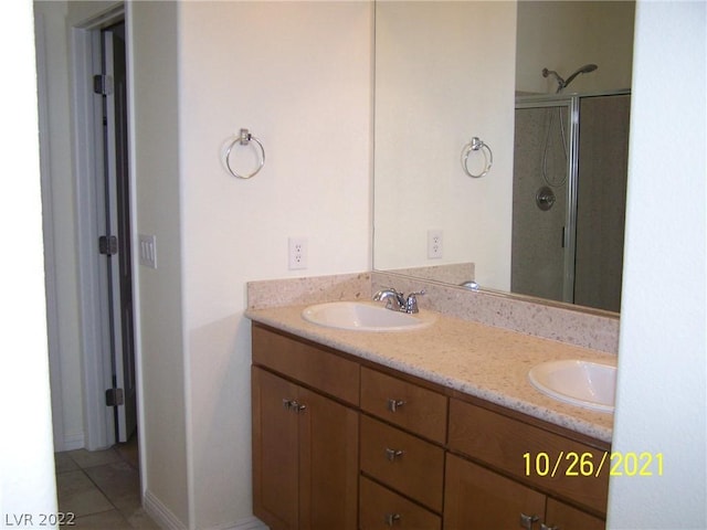 bathroom with walk in shower, dual bowl vanity, and tile flooring