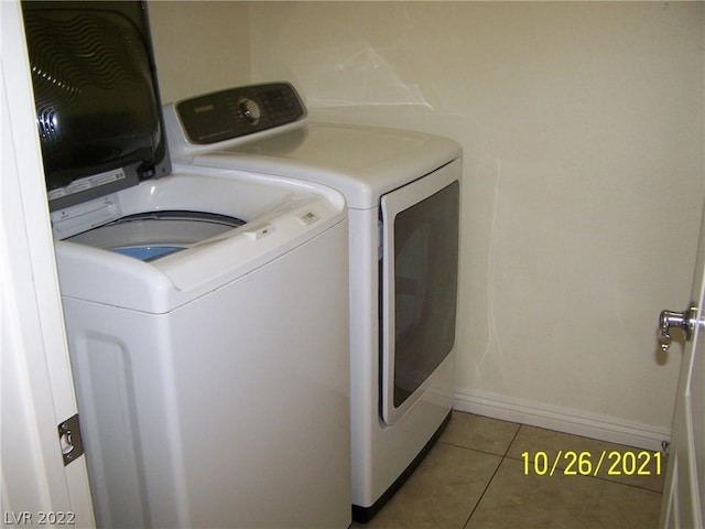 laundry area with tile floors and washer and dryer