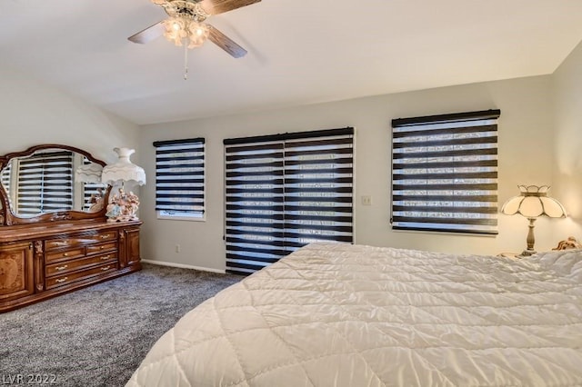 bedroom featuring ceiling fan and dark carpet