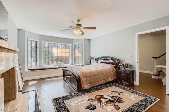 bedroom with light hardwood / wood-style floors and ceiling fan