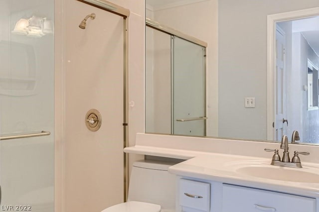 bathroom with vanity with extensive cabinet space, toilet, and walk in shower