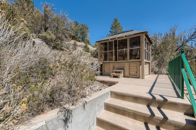 back of property with a sunroom