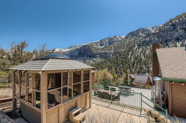 wooden deck featuring a mountain view and a gazebo