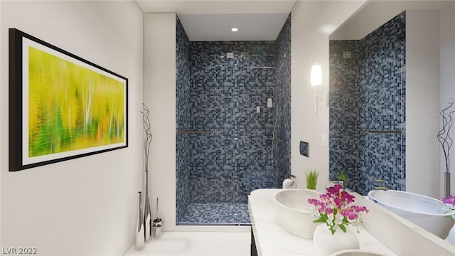 bathroom featuring double sink vanity and a tile shower