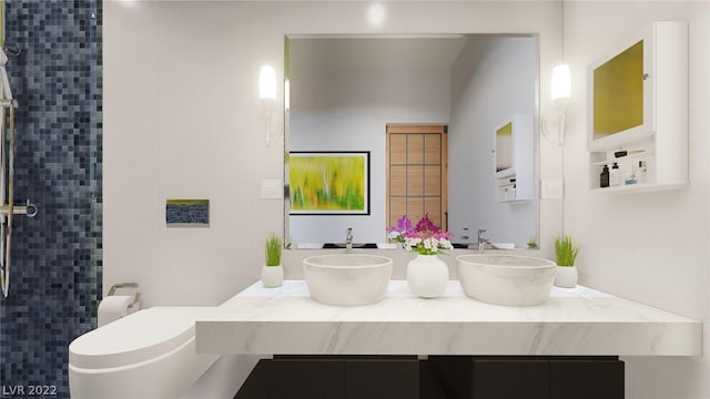 bathroom with double sink vanity and toilet