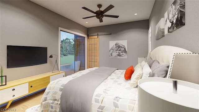 bedroom featuring a barn door, access to exterior, ceiling fan, and light wood-type flooring