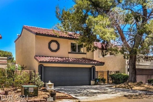 mediterranean / spanish home featuring a garage