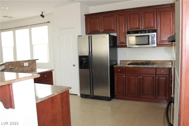 kitchen with light tile flooring and appliances with stainless steel finishes