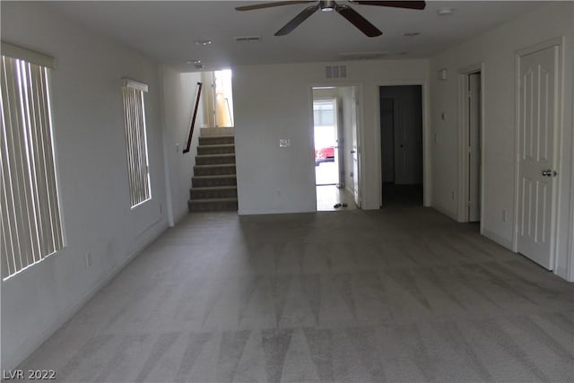 unfurnished room with light carpet and ceiling fan