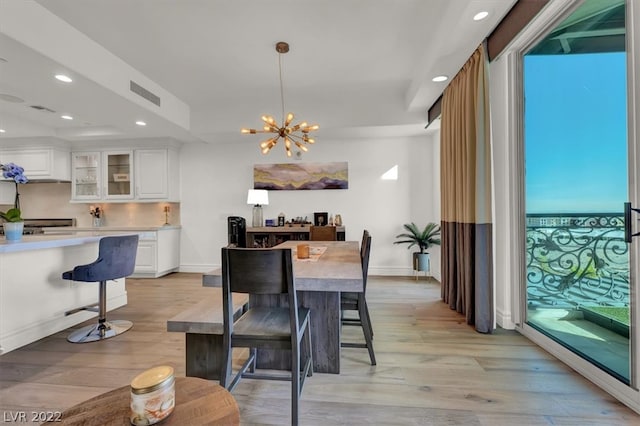 dining room with an inviting chandelier and light wood-type flooring