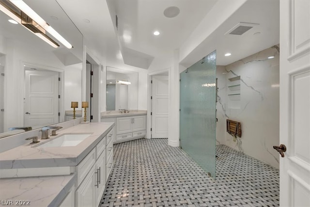 bathroom with a shower, tile floors, and vanity