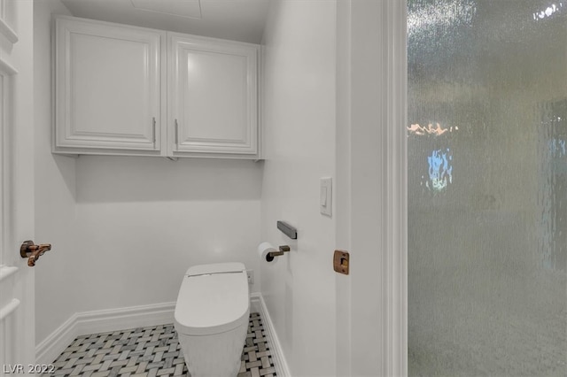 bathroom with toilet and tile flooring