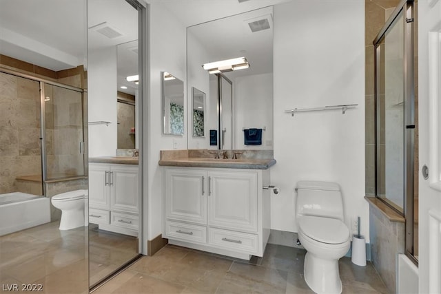 full bathroom with tile flooring, combined bath / shower with glass door, toilet, and vanity