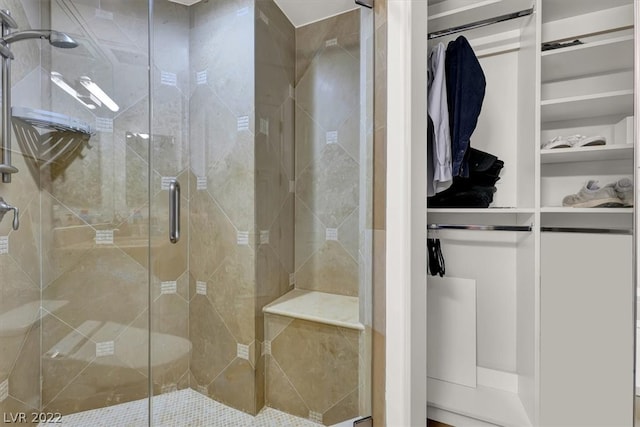 bathroom with a shower with door