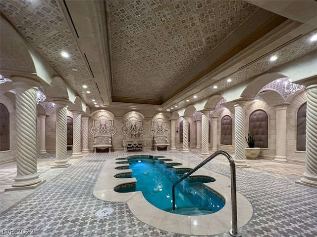 view of swimming pool featuring a patio and an indoor hot tub