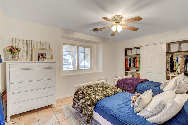 tiled bedroom featuring ceiling fan