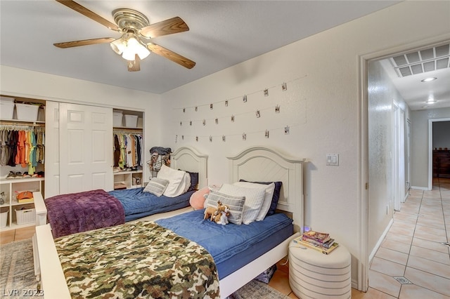 tiled bedroom with a closet and ceiling fan