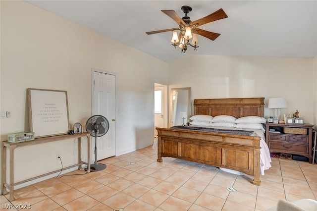 bedroom featuring ceiling fan, light tile patterned floors, and vaulted ceiling