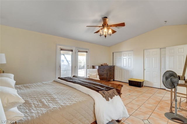 tiled bedroom featuring multiple closets, ceiling fan, access to outside, and vaulted ceiling