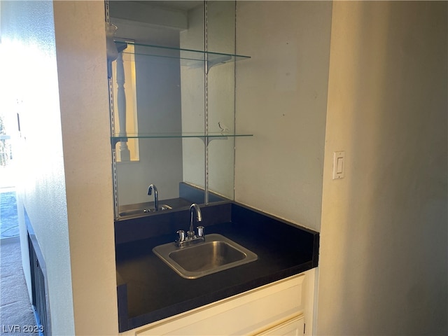 kitchen featuring white cabinetry and sink