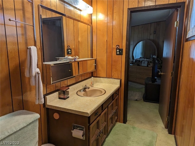 bathroom with vanity and wood walls