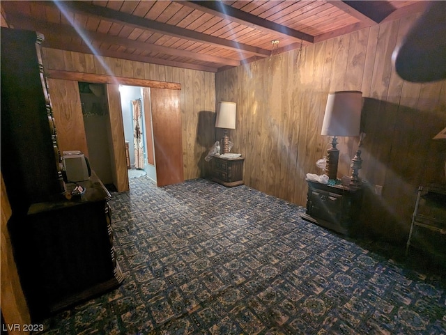 interior space featuring wood ceiling, wooden walls, and beamed ceiling