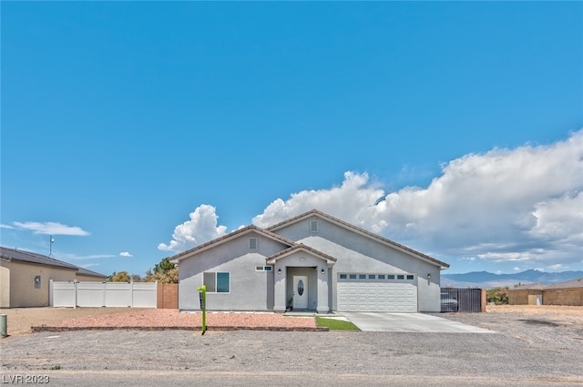 view of front of property featuring a mountain view and a garage