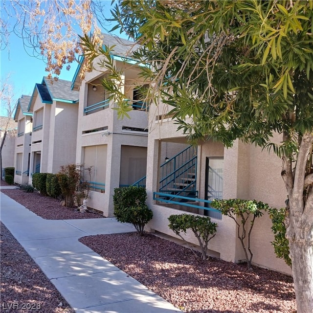 view of side of property with a balcony