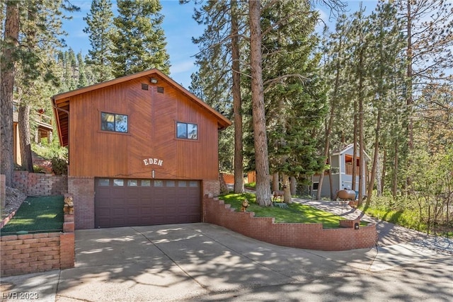 4095 Tyrol Way, Mount Charleston, NV 89124 - chalet / cabin featuring concrete driveway, an attached garage, and brick siding