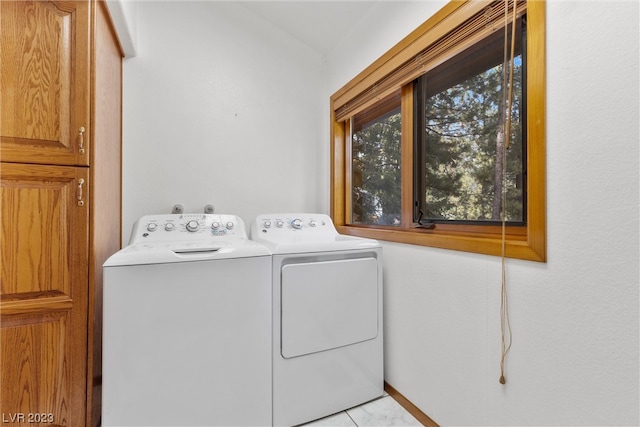 laundry room featuring light tile patterned floors and washer and clothes dryer