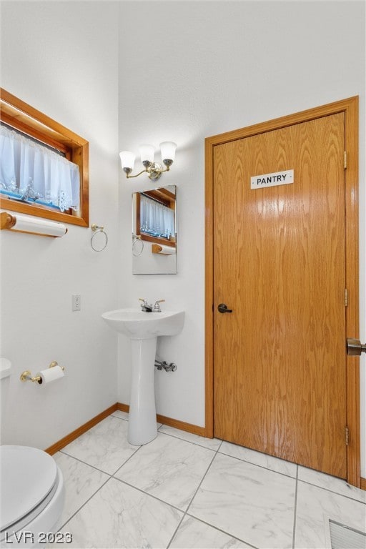 bathroom featuring toilet and sink