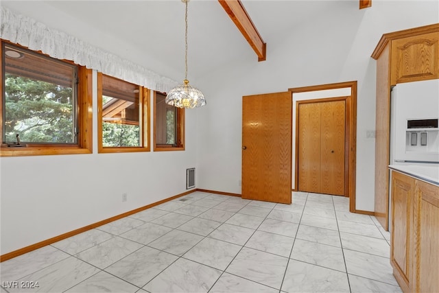 unfurnished dining area featuring a notable chandelier and vaulted ceiling