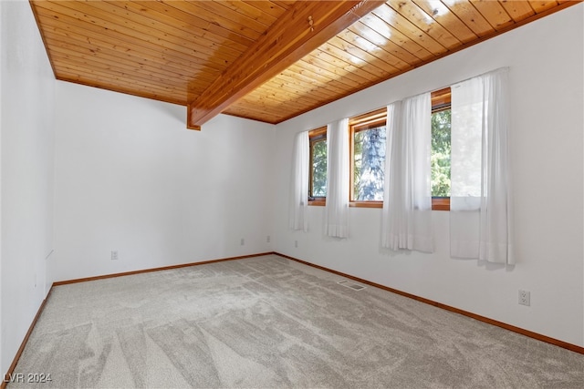 unfurnished room with light colored carpet, beam ceiling, and wooden ceiling