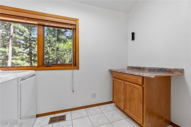 bathroom featuring washer and clothes dryer and tile patterned floors