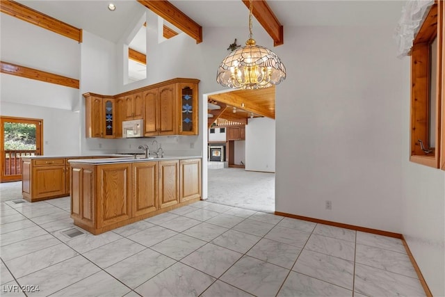 4095 Tyrol Way, Mount Charleston, NV 89124 - kitchen with white microwave, beamed ceiling, a chandelier, a peninsula, and glass insert cabinets