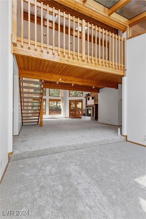 4095 Tyrol Way, Mount Charleston, NV 89124 - unfurnished living room featuring carpet floors and a wood ceiling with exposed beams