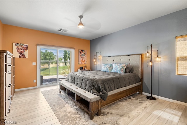 bedroom with access to exterior, light hardwood / wood-style floors, and ceiling fan