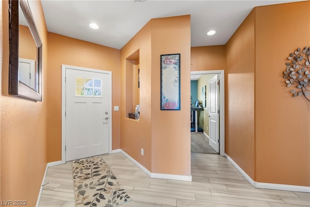 view of carpeted entrance foyer