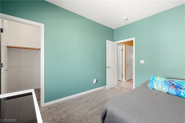 bedroom with light carpet and a closet