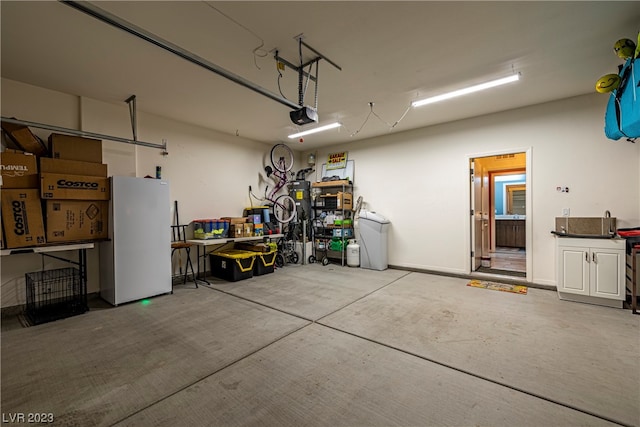 garage with white fridge and a garage door opener