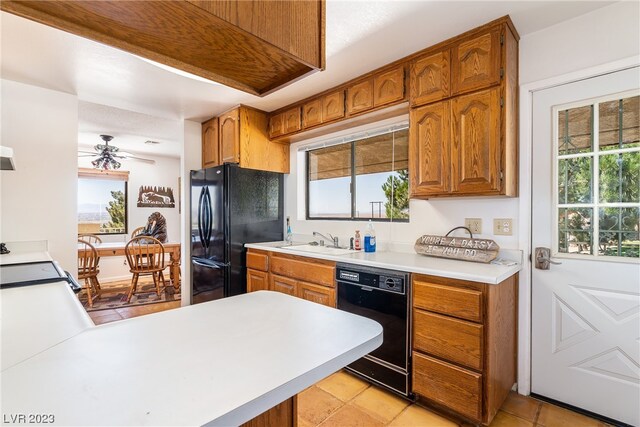 kitchen with light tile floors, ceiling fan, black appliances, and sink