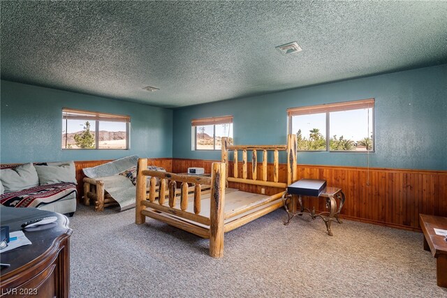 carpeted bedroom featuring a textured ceiling