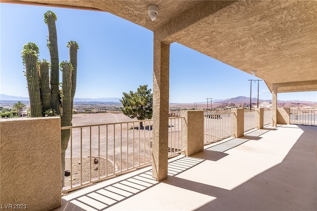 view of terrace with a balcony and a mountain view