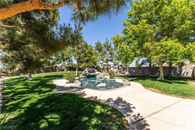 view of property's community featuring a yard and a swimming pool