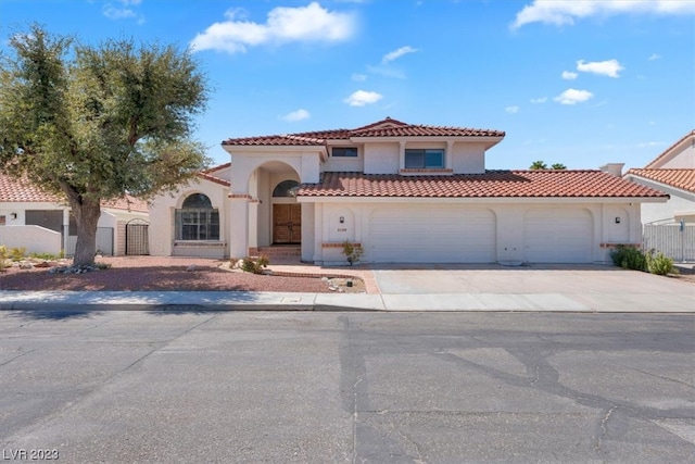 mediterranean / spanish-style house with a garage