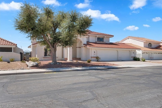 mediterranean / spanish-style home with a garage