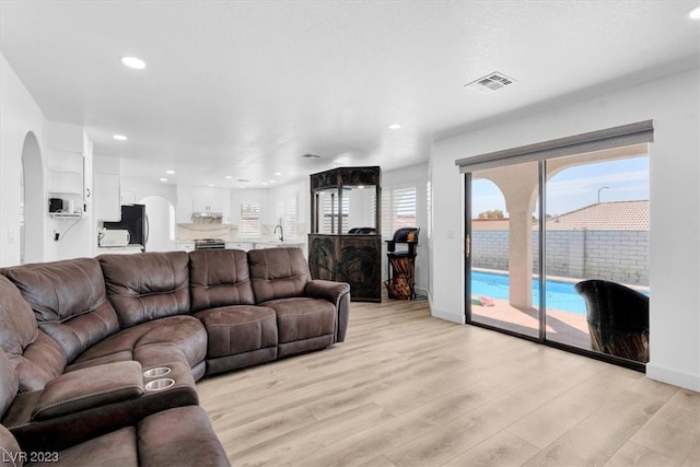 living room with a healthy amount of sunlight and light wood-type flooring